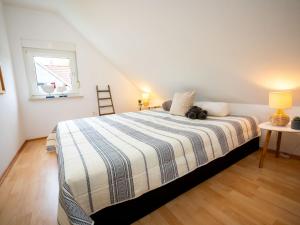 a bedroom with a bed with a teddy bear on it at Holiday Home Neles Kate am Diemelsee by Interhome in Helminghausen