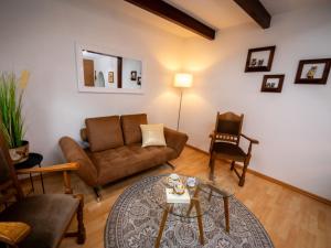 a living room with a couch and a table at Holiday Home Neles Kate am Diemelsee by Interhome in Helminghausen +30 photos