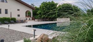 a swimming pool in a yard next to a house at Villa dei tigli - Altamura in Altamura
