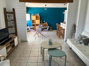 a living room with a couch and a table at Ty Bihan in Saint-Potan