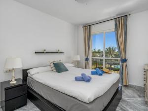 a bedroom with a large bed and a large window at Apartment Lorcrisur by Interhome in Marbella