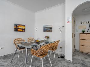 a dining room with a table and chairs at Apartment Lorcrisur by Interhome in Marbella +33 photos