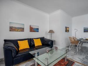 a living room with a black couch and a table at Apartment Lorcrisur by Interhome in Marbella
