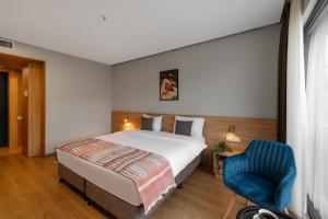 Postel nebo postele na pokoji v ubytování Hotel Memoir Kazbegi by DNT Group
