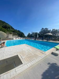 a large swimming pool with a clear blue water at Moneglia - Le Case di Bart in Moneglia