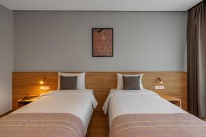 Postel nebo postele na pokoji v ubytování Hotel Memoir Kazbegi by DNT Group