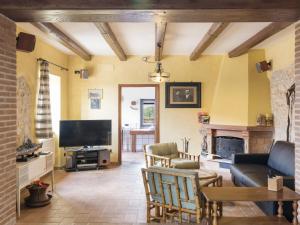 a living room with a couch and a tv at Holiday Home Colleflaviano by Interhome in Casperia