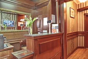 a room with a counter with a vase of flowers on it at Vila Terazije in Belgrade