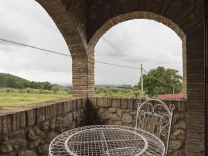 a bench sitting on a stone wall with a window at Holiday Home Colleflaviano by Interhome in Casperia