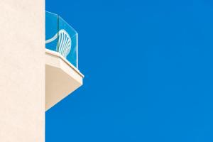 a building with a blue door and a chair at Grand Meeting Hotel in Rimini