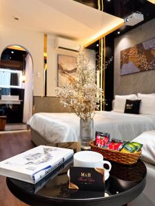 a coffee table with a book and a basket of candy at M&H Hotel in Ho Chi Minh City