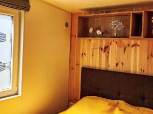 a bedroom with a bed and a wooden wall at Holiday Home Lieblingsplatz by Interhome in Wemding