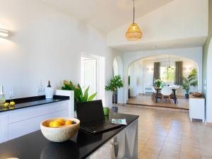 a kitchen with a table with a bowl of oranges on it at Villa Atardecer by Interhome in Torrox Costa