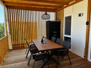 a dining room table and chairs on a deck at Mobile home Max in Drage