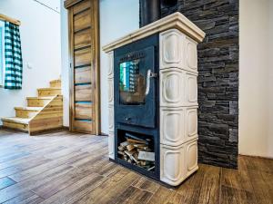 a fireplace in a room with a stone wall at Holiday Home JaZ by Interhome in Bedřichov +25 photos