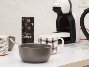 a cup on a counter with cups and a coffee maker at Apartment Le 55Cici by Interhome in Bouveret