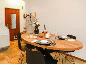 a wooden table with chairs and a bottle of wine at Apartment Le 55Cici by Interhome in Bouveret +22 photos