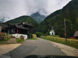 a road leading to a village with a mountain at Skalca in Kamniška Bistrica