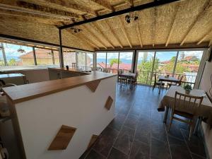 a large room with tables and chairs and windows at GOPO Guesthouse Elshani in Ohrid