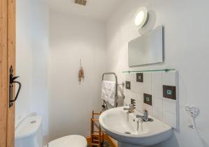 a white bathroom with a sink and a toilet at St. Coombs Farmhouse in Holy Island +36 photos