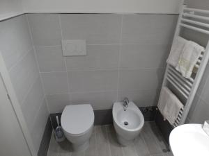 a bathroom with a toilet and a sink at Le Cupe in Corciano +26 photos