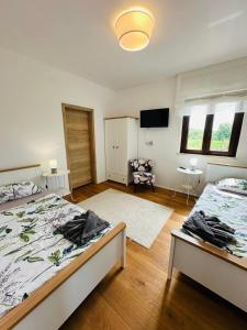 a bedroom with two beds and a flat screen tv at Villa Seaside in Krk