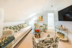 a living room with a couch and two chairs at The Nici in Bournemouth +37 photos