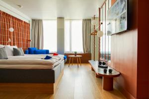赫爾辛基的住宿－Hobo Helsinki，酒店客房配有一张床铺和一张桌子。