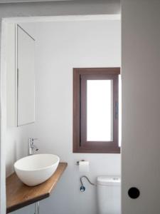 a bathroom with a white sink and a toilet at Casa Nueva in Jimena de la Frontera