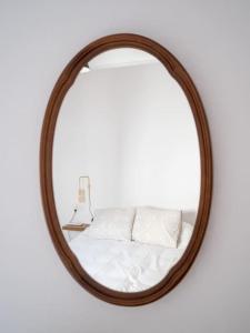 a wooden mirror with a bed in front of it at Casa Nueva in Jimena de la Frontera