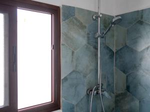 a shower in a bathroom with a glass window at Casa Nueva in Jimena de la Frontera +15 photos