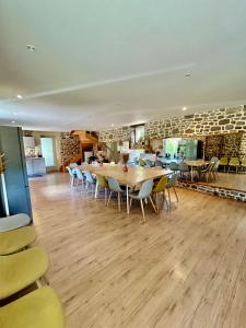 a dining room with a table and chairs at Moulin du Gast 35pers : jacuzzi sauna billard baby in Le Gast