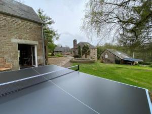 a ping pong table in the backyard of a house at Moulin du Gast 35pers : jacuzzi sauna billard baby in Le Gast +15 photos