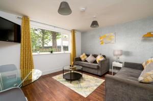 a living room with a couch and a window at K Suites - Station Road in Hinckley