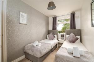 a room with two beds and a window at K Suites - Station Road in Hinckley