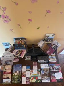 a table with books and magazines on top of it at La Chambre Des Issarts in Gevrey-Chambertin
