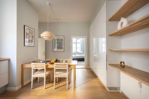a kitchen with a dining room table and chairs at Stylish Apartment at Best Location in CPH by The Canals in Copenhagen