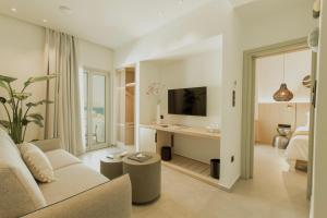 a living room with a couch and a desk at Opal Paros in Naousa
