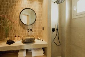 a bathroom with a sink and a mirror at Opal Paros in Naousa