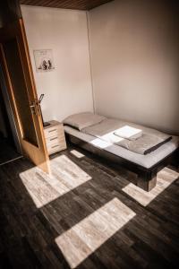 a small room with a bed and a wooden door at Ferienwohnung-Bali in Bad Liebenzell