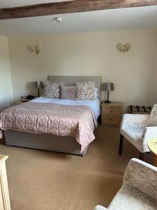 1 dormitorio con 1 cama y 1 silla en Waveney House Hotel en Beccles