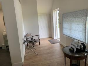 a living room with a chair and a table at DOMAINE ST GERMER in Reilly