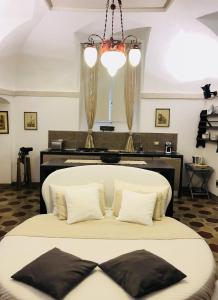 a bedroom with a large white bed with pillows at Historic house by the lake La Renée Casa Vacanza in Predore