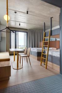a room with a bunk bed and a table and chairs at Comfort Hotel Helsinki Airport in Vantaa