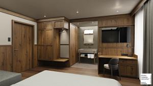 baño con armarios de madera, lavabo y TV en Hotel Serena Cortina, en Cortina dʼAmpezzo