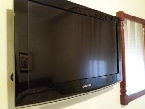 a large flat screen television hanging on a wall at Hotel Avenida in Gijón