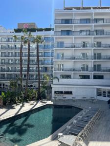 a swimming pool in front of a large building at Gran Hotel Flamingo-Adults Only older 18 years old in Lloret de Mar