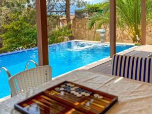 a tray of wine bottles on a table next to a pool at Villa Siesta Kusadasi in Kuşadası +49 photos