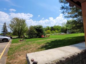 a yard with a park with a table and chairs at Edelweiss Inn Nova Scotia in Middleton