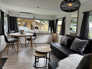 a living room with a couch and a table at Vakantiepark Klein Vink - A10 in Arcen